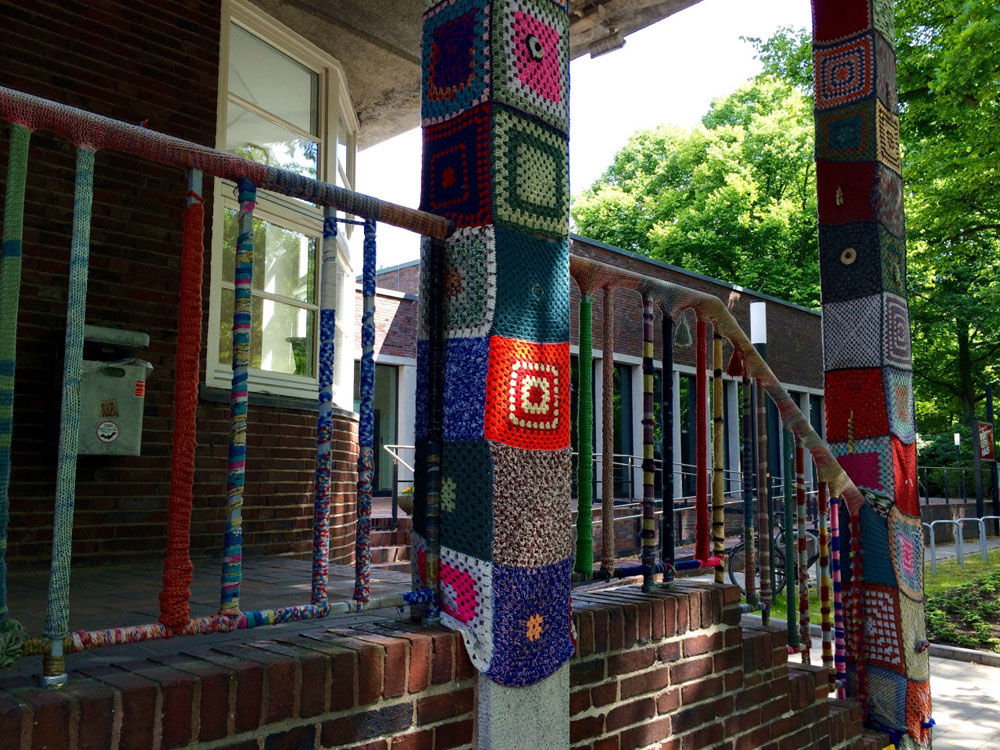 Columns and railings decorated with knitted patterns.